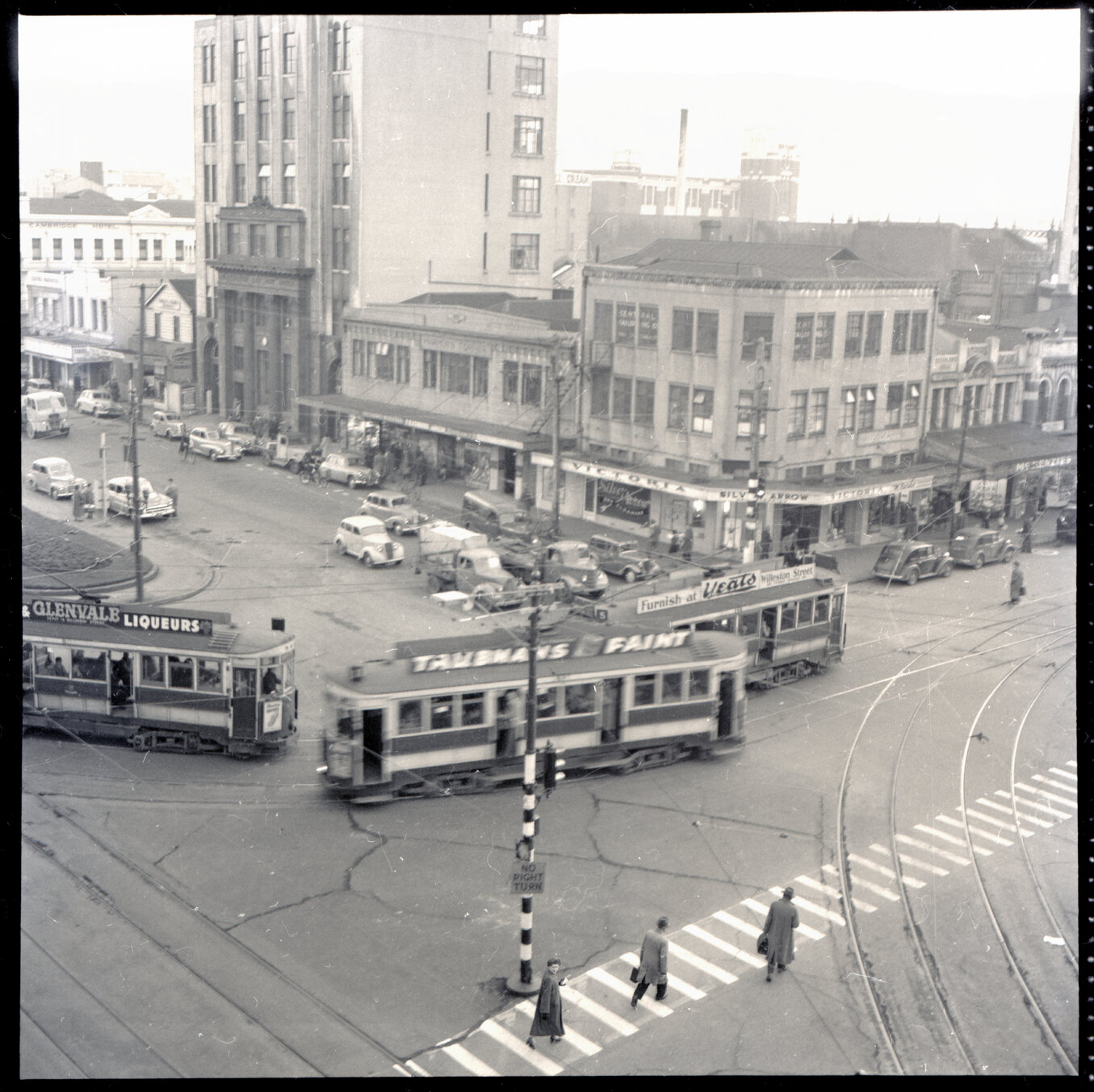 a. Elevated views of Courtenay Place, Cambridge and Kent Terrace from the top of the Embassy Theatre. Mens Toilet / Taj Mahal Restaurant, Tramcars, motor vehicles, Queen Victoria Statue, Cambridge Hotel 