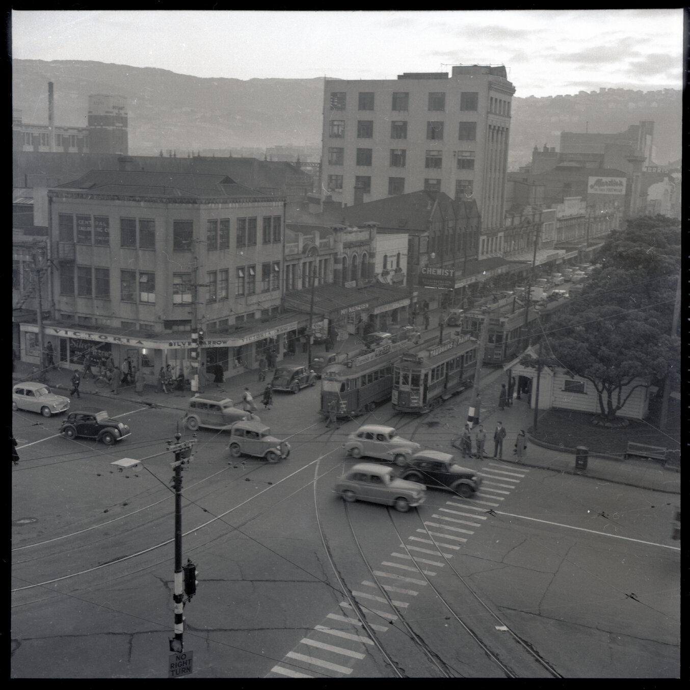 g. Elevated views of Courtenay Place, Cambridge and Kent Terrace from the top of the Embassy Theatre. Mens Toilet / Taj Mahal Restaurant, Tramcars, motor vehicles, Queen Victoria Statue, Cambridge Hotel 