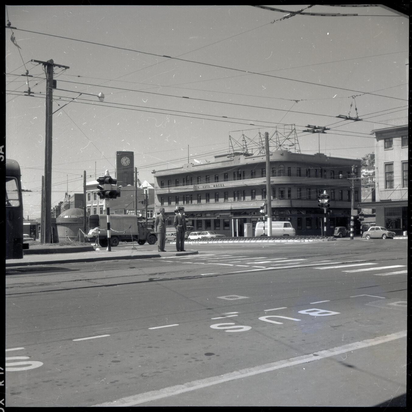 f. Elevated views of Courtenay Place, Cambridge and Kent Terrace from the top of the Embassy Theatre. Mens Toilet / Taj Mahal Restaurant, Tramcars, motor vehicles, Queen Victoria Statue, Cambridge Hotel 