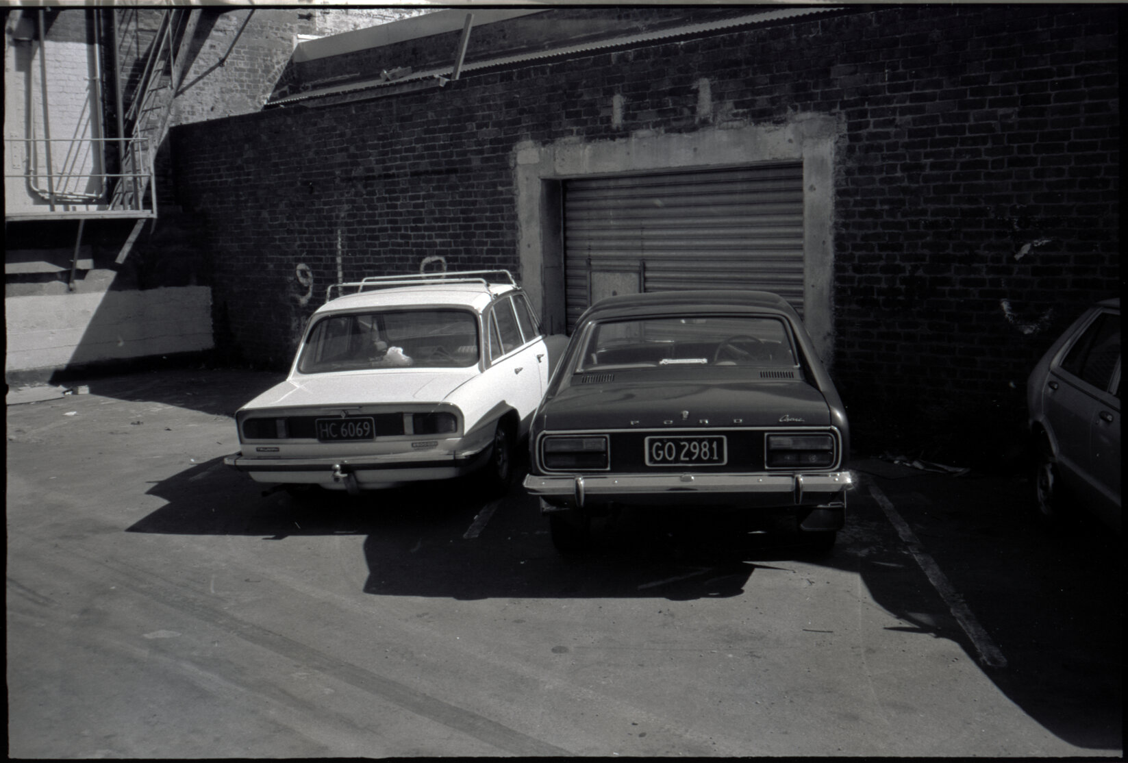 Parked cars in front of a garage