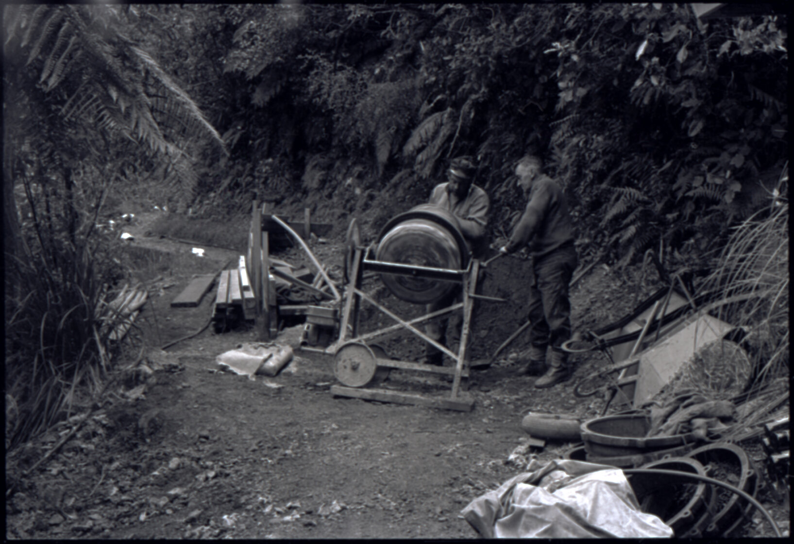 Orongorongo and Wainuiomata water catchment area, two workers with a cement mixer