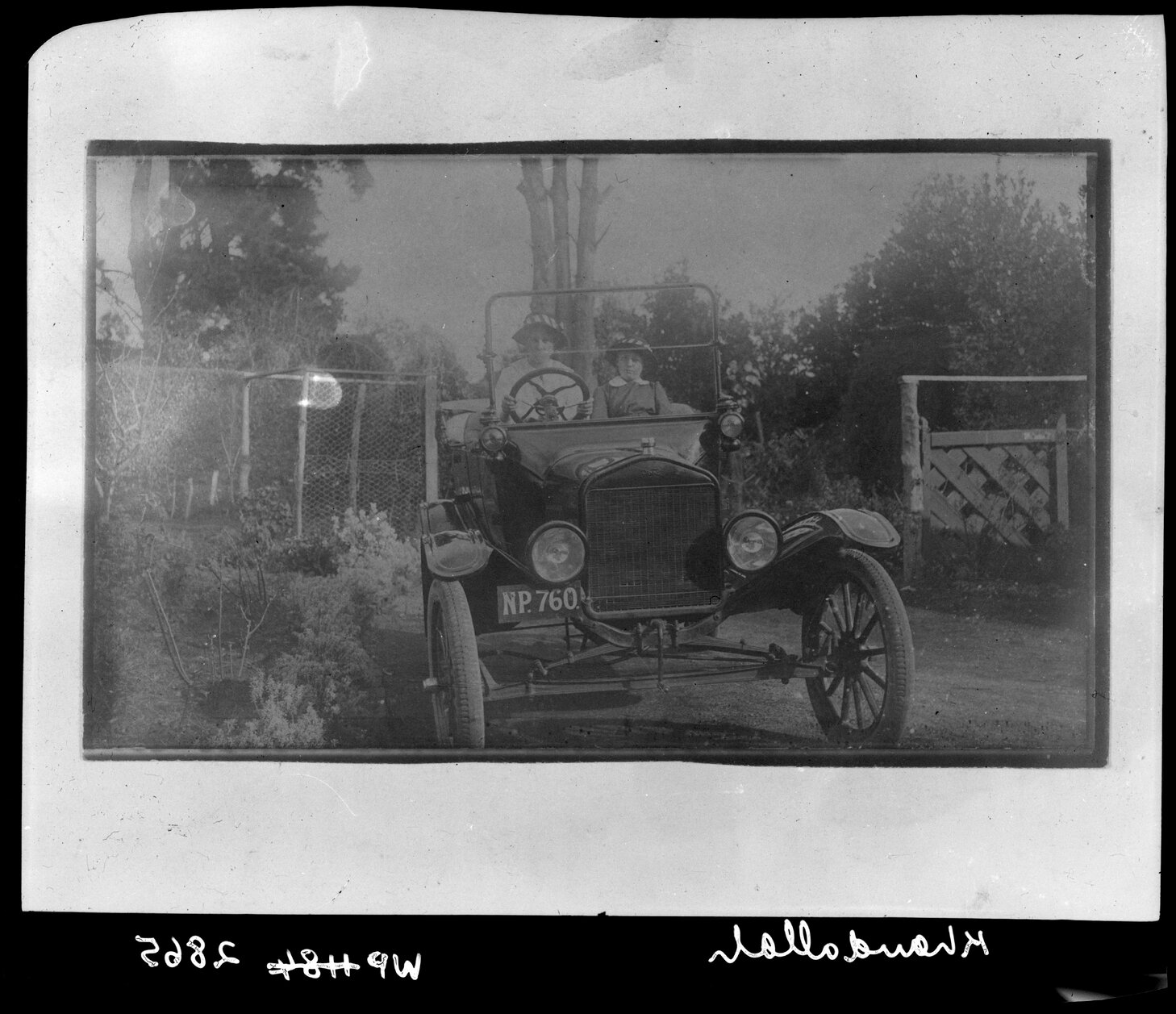 Two women driving motor vehicle