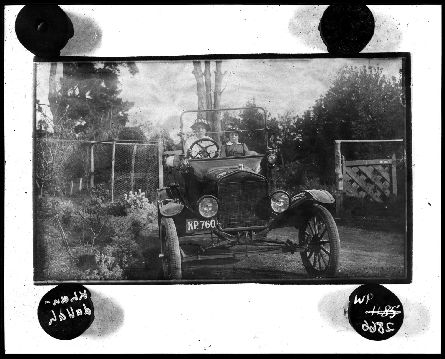 Two women driving motor vehicle