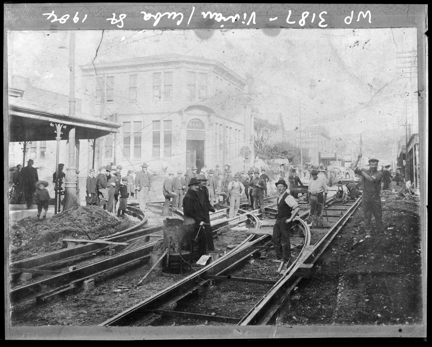 Workmen laying tram tracks, corner of Vivian Street and Cuba Street