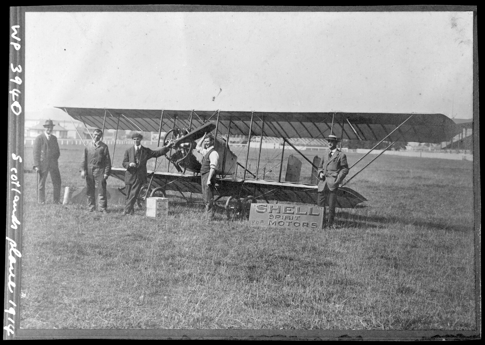 J. W. H. Scotland (standing left of Anzani engine) with his Type C Caudron biplane "Bluebird" at the Addington Showgrounds