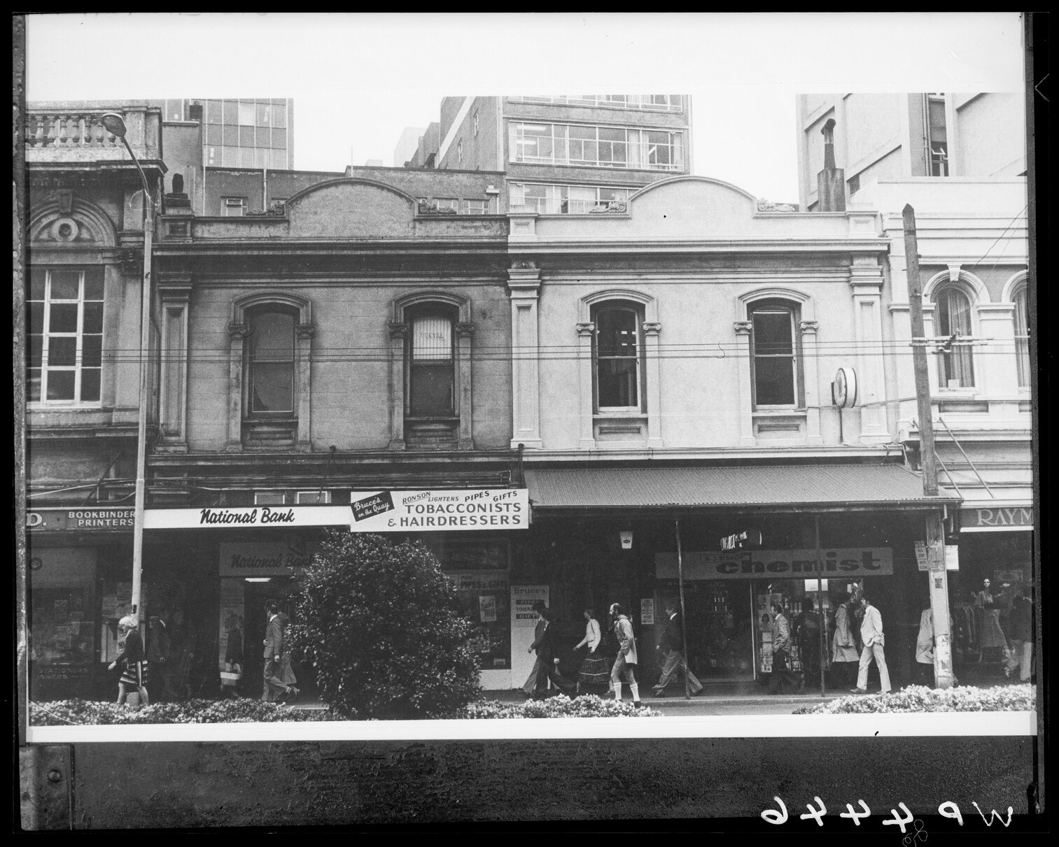 Lambton Quay, facades of buildings now demolished - National Bank, Tobacconist / Hairdresser and S J Bishop Chemist
