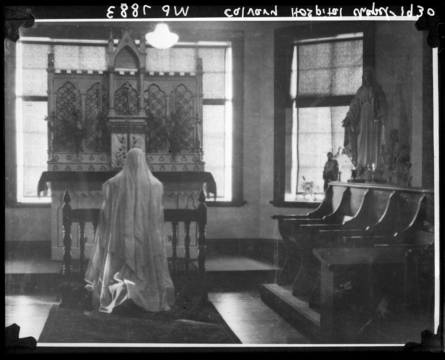 Nun praying at altar, Chapel, Calvary Hospital