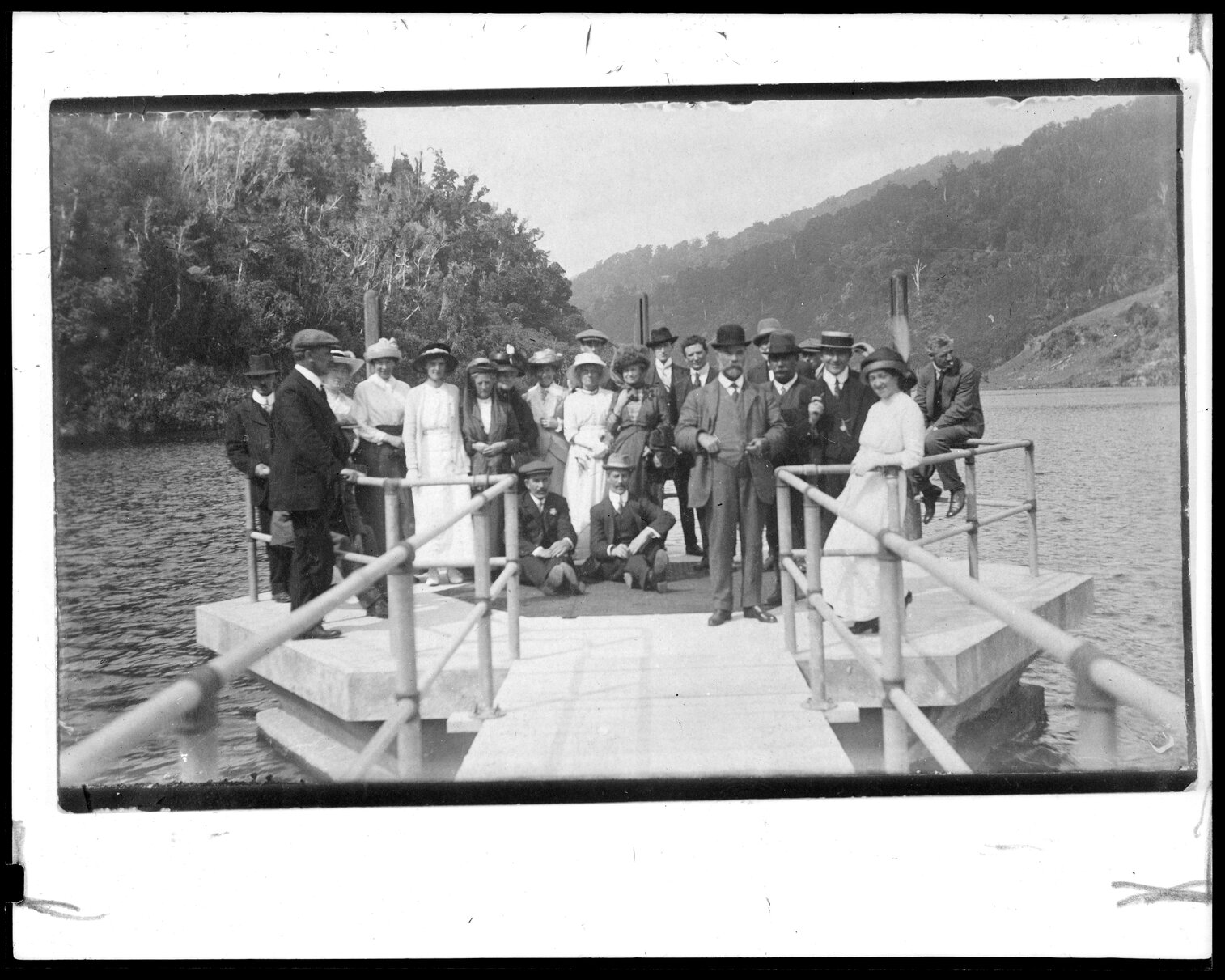 Group of people with Morton Dam in background, Wainuiomata