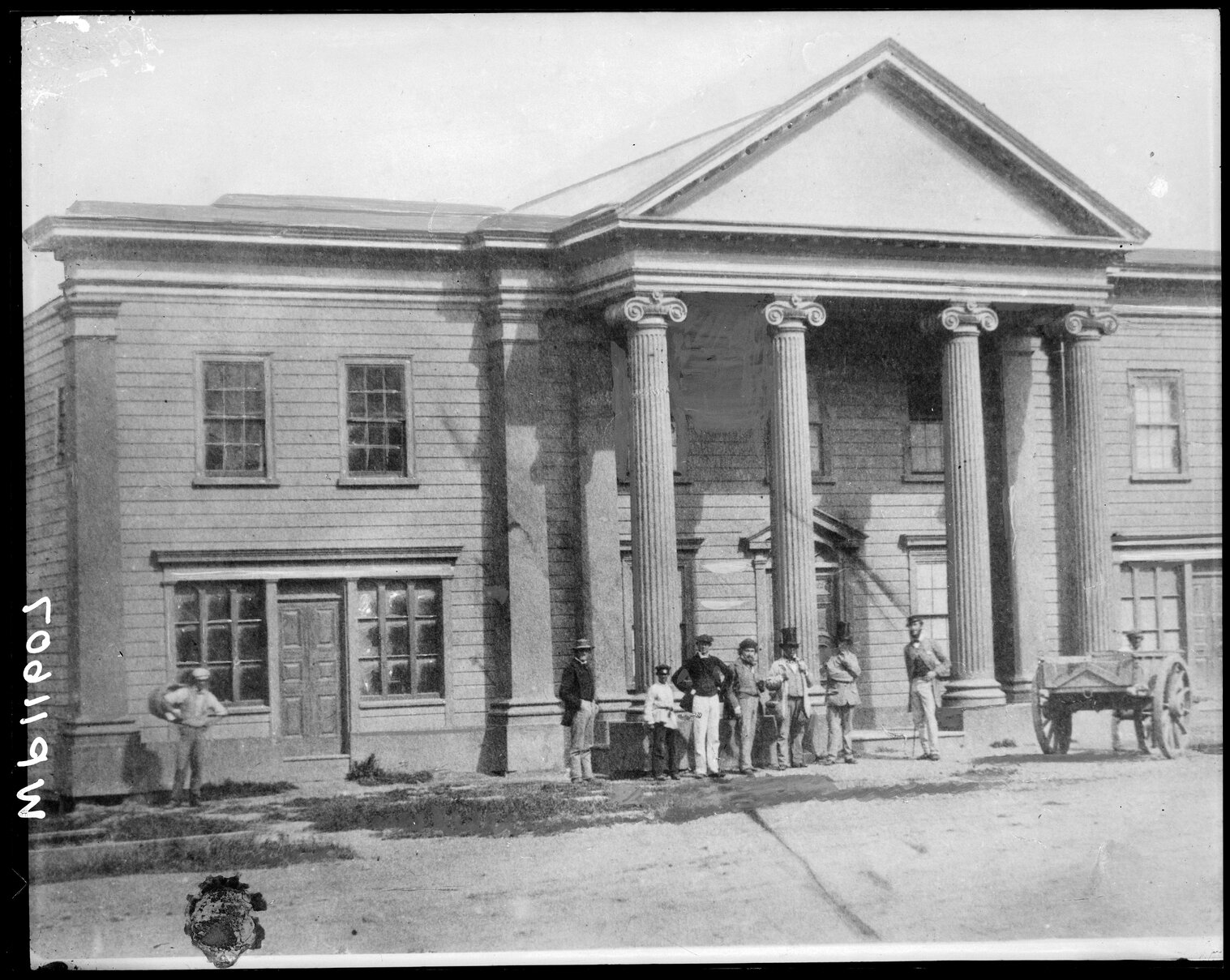 Group of men standing outside the Oddfellows Hall, foundation stone laid in 1859