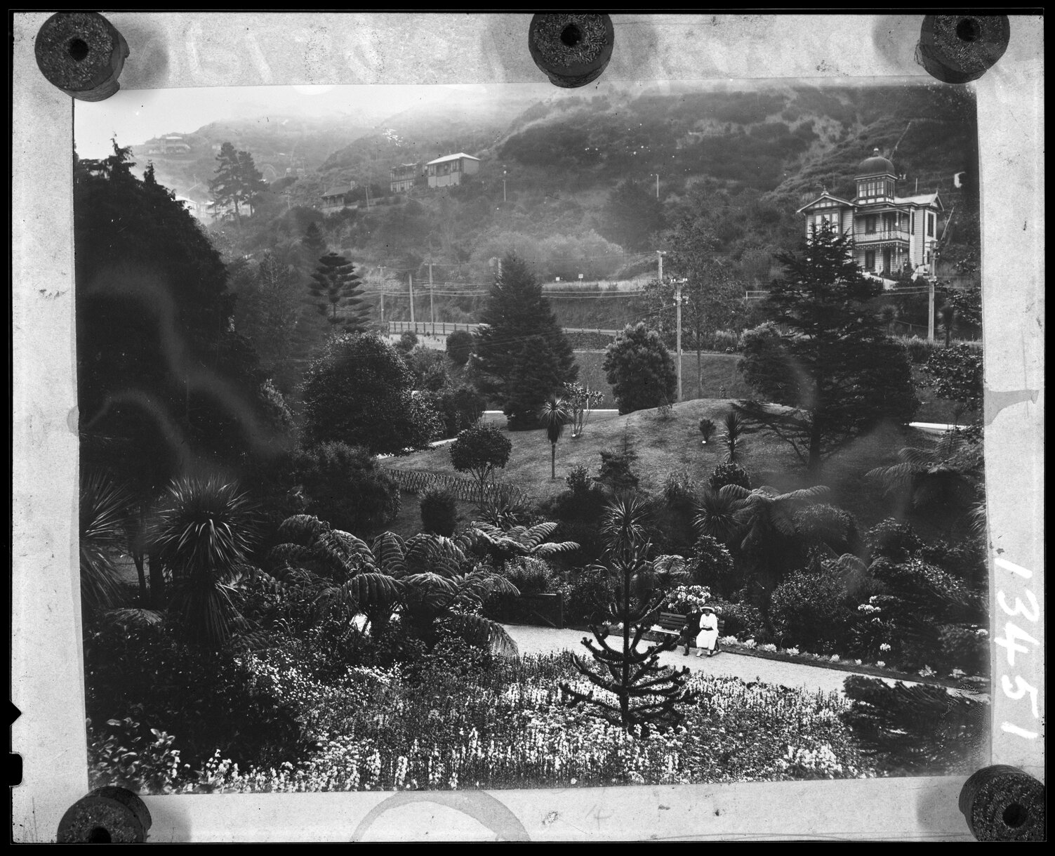 Elevated view of couple sitting on park bench, Botanic Gardens