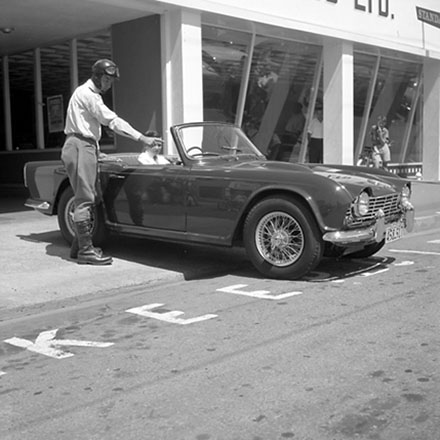 a. Traffic Department, Traffic Officer with man in sportscar.