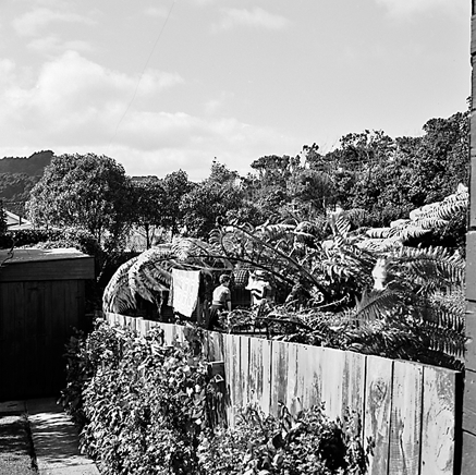 c. two women hanging out washing on a rotary clothes line