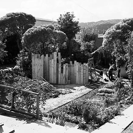 d. two women hanging out washing on a rotary clothes line