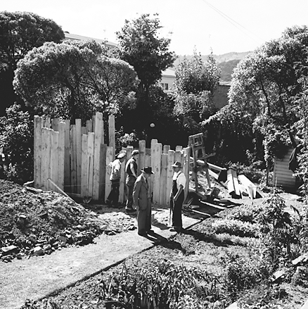 e. two women hanging out washing on a rotary clothes line