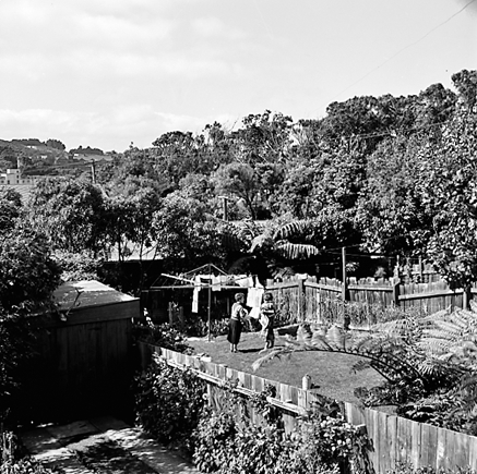 f. two women hanging out washing on a rotary clothes line