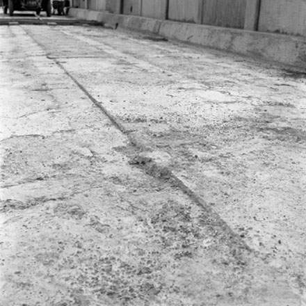 k. Construction of new bridge, workmen, machinery, motor vehicles. Road is being resurfaced