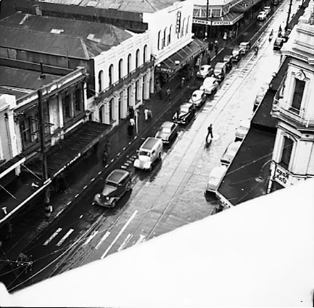 d. Elevated view of Cuba Street from James Smith Corner. Royal Oak Hotel on the left. Woolworths Building on the corner of Dixon Street. Motor vehicles