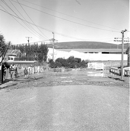 c. People looking at mud and debris