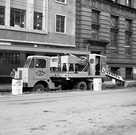 b. Looking east. Workmen are digging a trench, Gradall machine on back of a truck