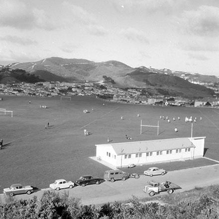 l. Elevated view of Soccer game, motor vehicles in the foreground