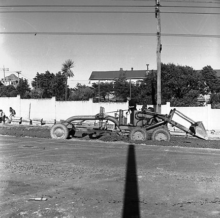 b. woman standing at bus stop