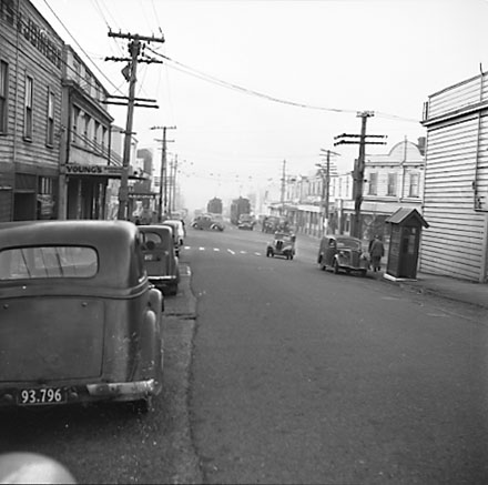 b. Looking north. Motor vehicles, tramcars, shops