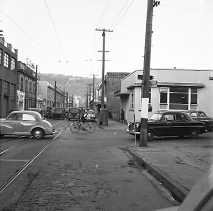 a. Intersection, boy on bicycle, motor vehicles, looking east
