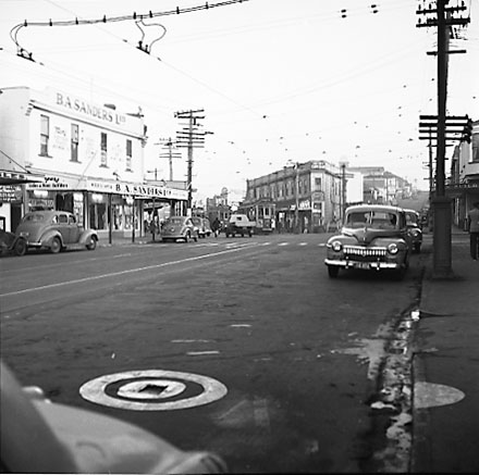 a. John Street and Riddiford Street intersection, pedestrians, tramcars, motor vehicles, retail buildings