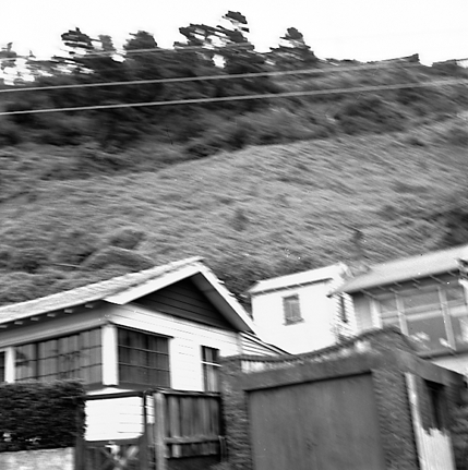 b. Slip in slope above building. Damage to building