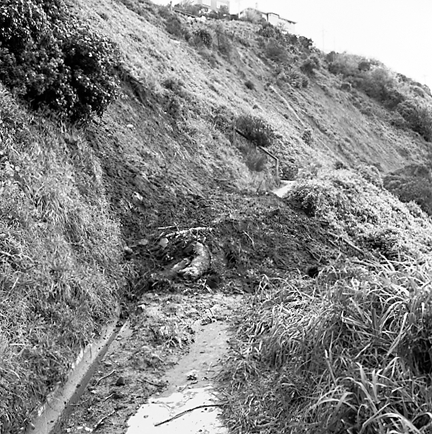 e. Slip in slope above building. Damage to building