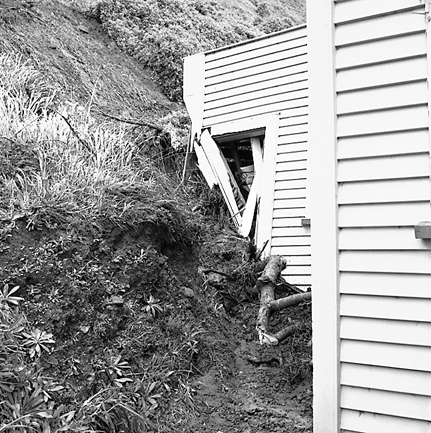 g. Slip in slope above building. Damage to building
