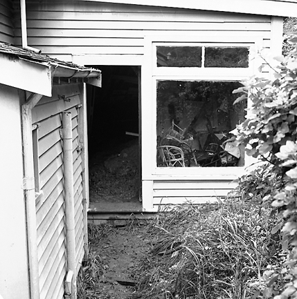 h. Slip in slope above building. Damage to building