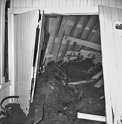 j. Slip in slope above building. Damage to building