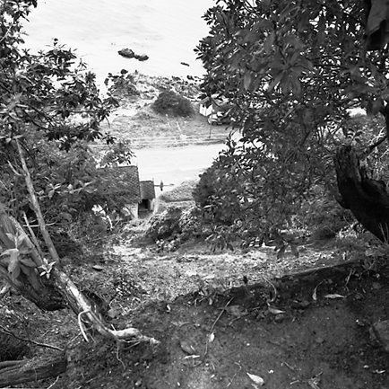 l. Slip in slope above building. Damage to building