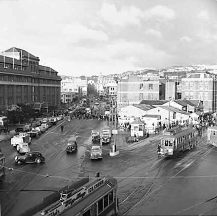 a. Elevated view of Railway Tram Terminus on Thorndon Quay / Featherston Street - people waiting for trams, buses, motor vehicles