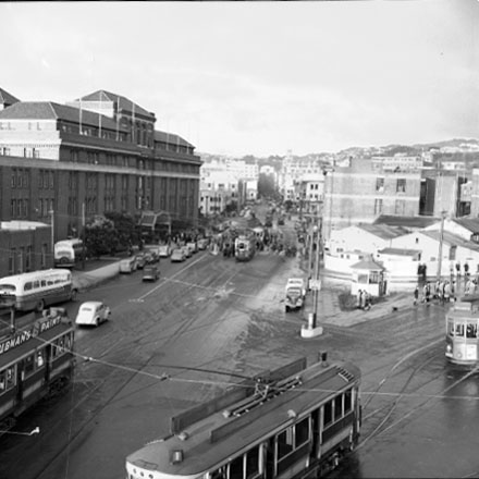 c. Elevated view of Railway Tram Terminus on Thorndon Quay / Featherston Street - people waiting for trams, buses, motor vehicles