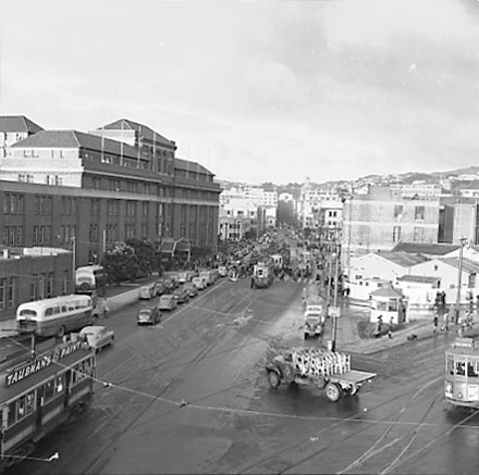 e. Elevated view of Railway Tram Terminus on Thorndon Quay / Featherston Street - people waiting for trams, buses, motor vehicles