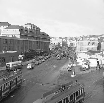 f. Elevated view of Railway Tram Terminus on Thorndon Quay / Featherston Street - people waiting for trams, buses, motor vehicles