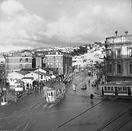 i. Elevated view of Railway Tram Terminus on Thorndon Quay / Featherston Street - people waiting for trams, buses, motor vehicles