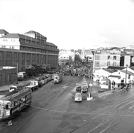 j. Elevated view of Railway Tram Terminus on Thorndon Quay / Featherston Street - people waiting for trams, buses, motor vehicles