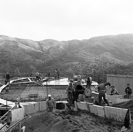 b. Workmen constructing reservoir