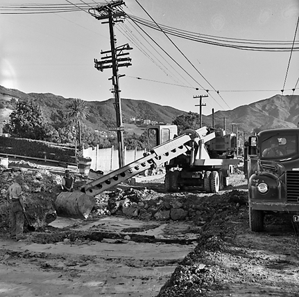 a. Road works, workmen and associated machinery, front end tractor, roller, grader, crane, trucks, motor vehicles