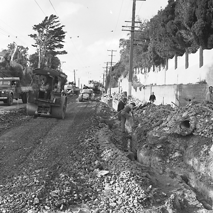 d. Road works, workmen and associated machinery, front end tractor, roller, grader, crane, trucks, motor vehicles