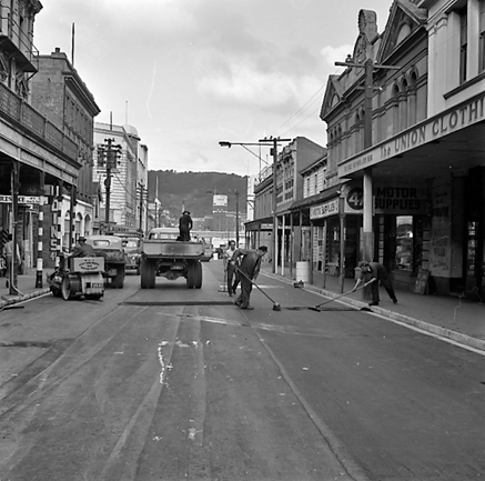 f. Looking east from Cuba Street to Taranaki Street intersection. Workmen are using an asphalt laying machine to re surface the road