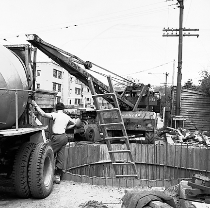 c. Workmen pouring concrete into base of underground pumping station