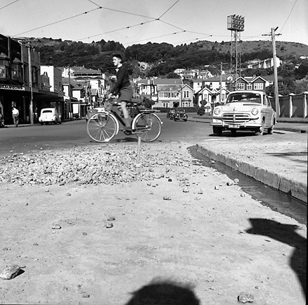 a. Basin Reserve on right, looking up Ellice Street. Boy on bicycle crossing road