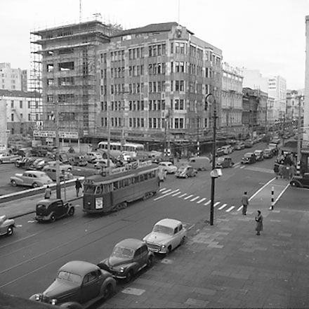 a. Elevated view of intersection, from roof of Town Hall Portico. Civic Chambers building (25-31 Cuba Street, 132-136 Wakefield Street) on the opposite corner, next to Anvil House (138-140 Wakefield Street) under construction. Motor vehicles, trolley bus,