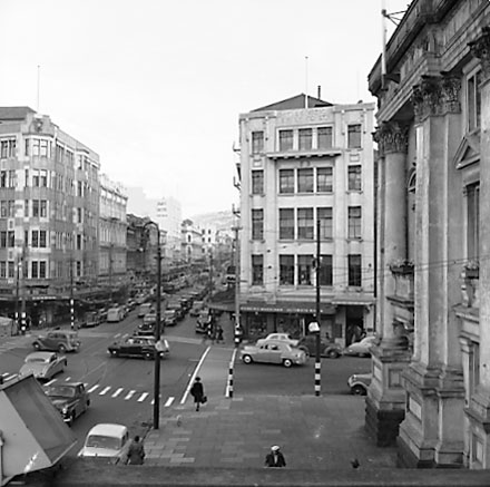 d. Elevated view of intersection, from roof of Town Hall Portico. Civic Chambers building (25-31 Cuba Street, 132-136 Wakefield Street) on the opposite corner, next to Anvil House (138-140 Wakefield Street) under construction. Motor vehicles, trolley bus,