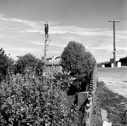 a. Repairs to road, footpath and kerbing. Single storey wooden dwelling on right