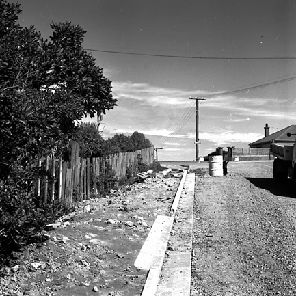 b. Single storey wooden dwelling on the corner of Orangi Kaupapa Road